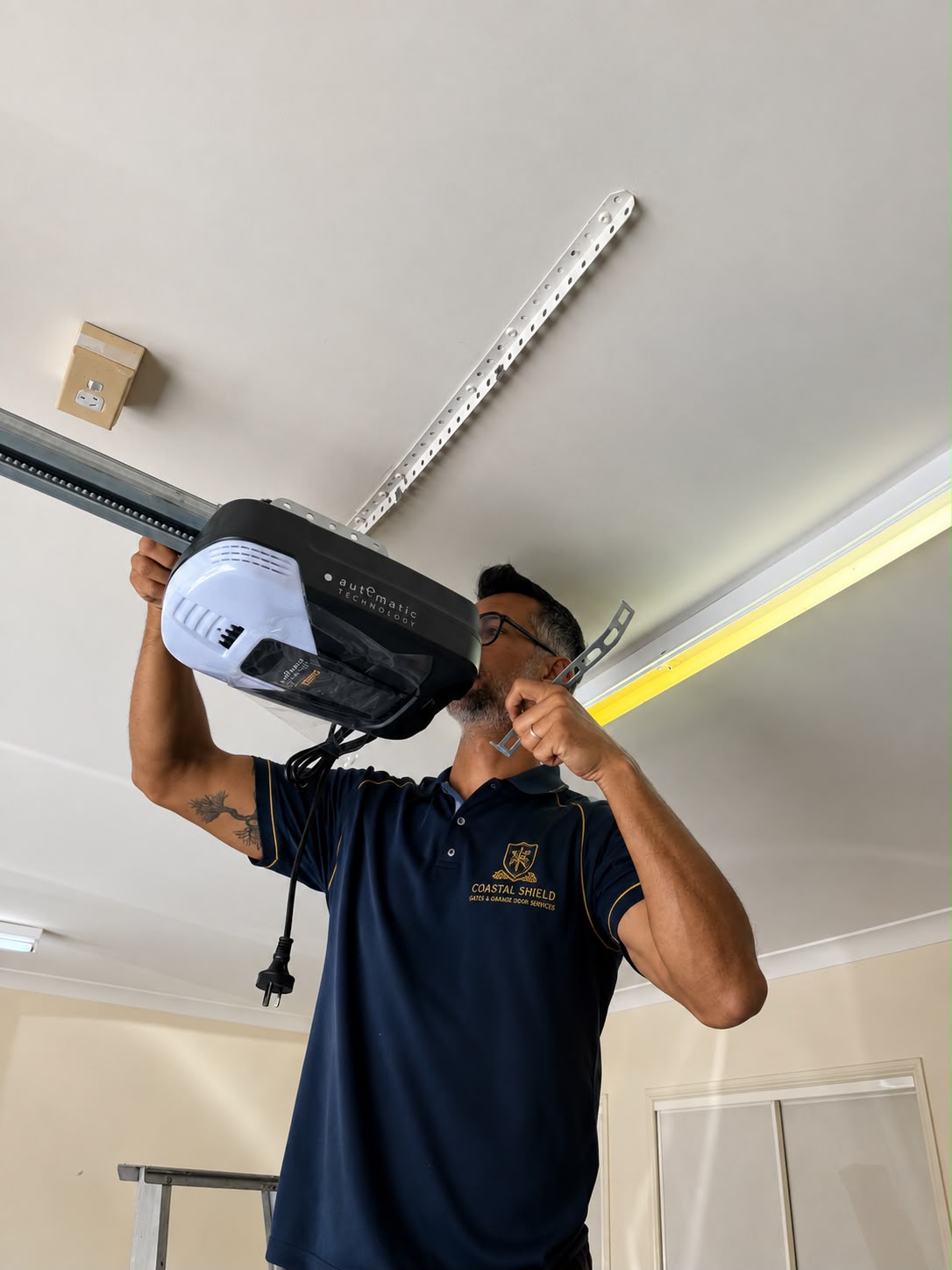 Technician servicing a garage door opener
